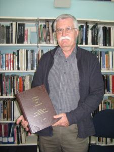 Terence King holding his book "A Sapper, an Officer and a Gentleman" 